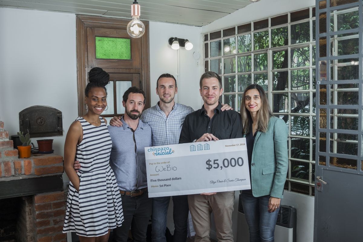 The winning team holding the first-place check