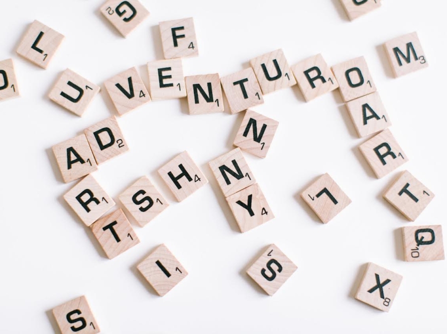 A hodge podge of scrabble letters on a white background