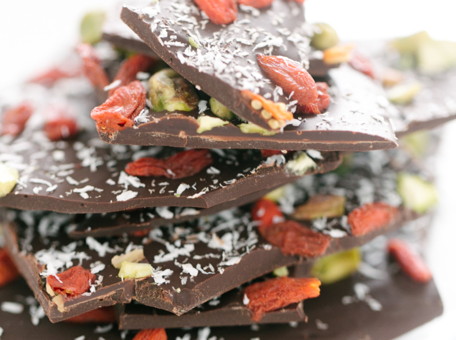 In the image we can see several plates of chocolate with nuts.