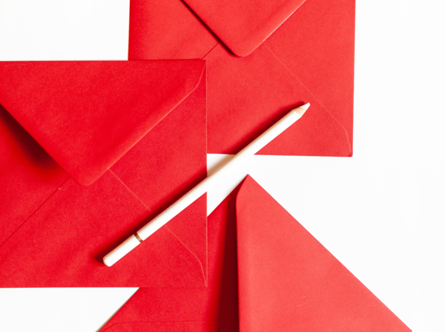 In the image, you can see three red envelopes and a white pen