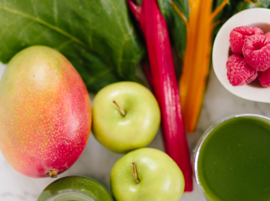 In the image we can see totally natural vegetables, fruits and juices.