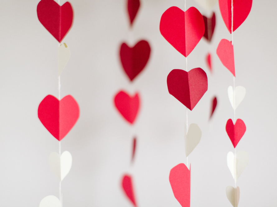 In the image we can see a curtain of hearts made of paper and thread